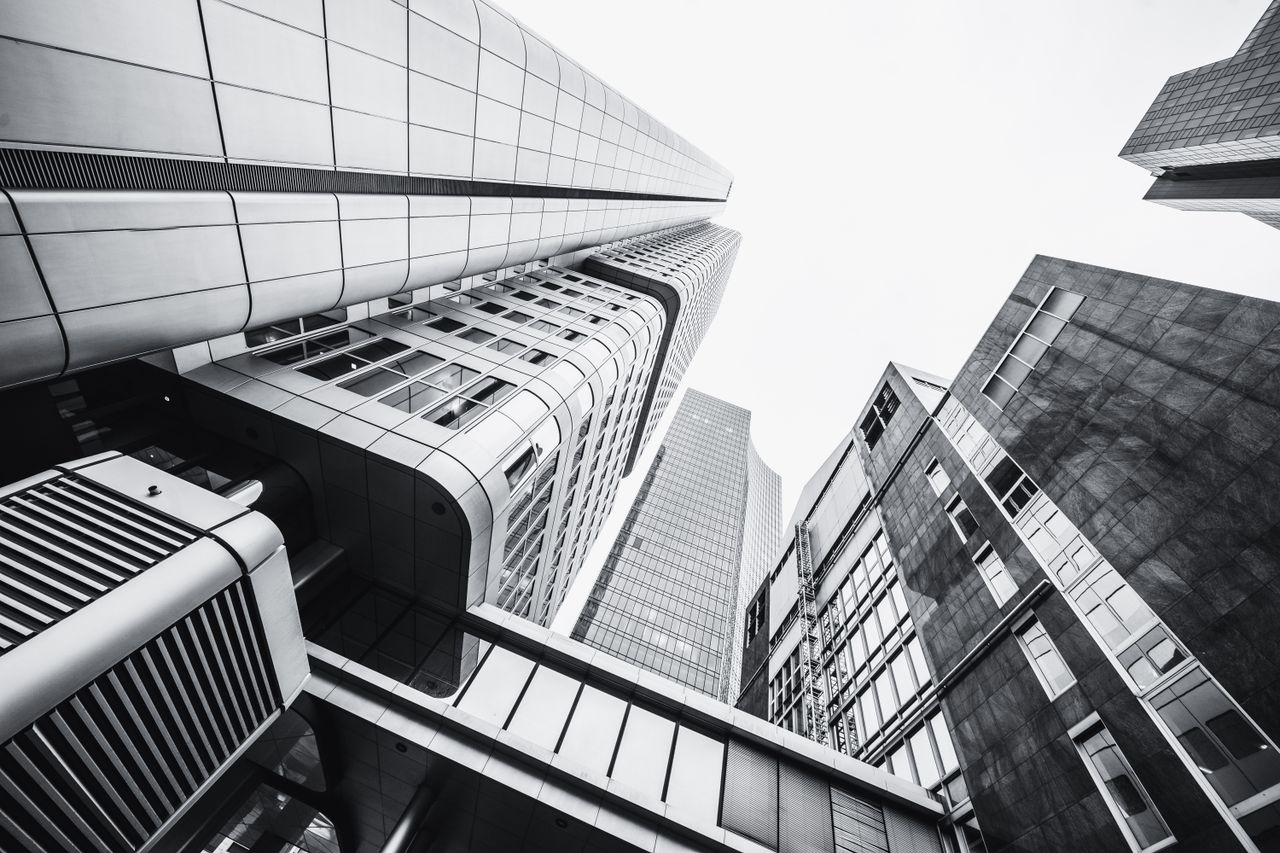Services Dramatic low angle shot of modern skyscrapers in monochrome.